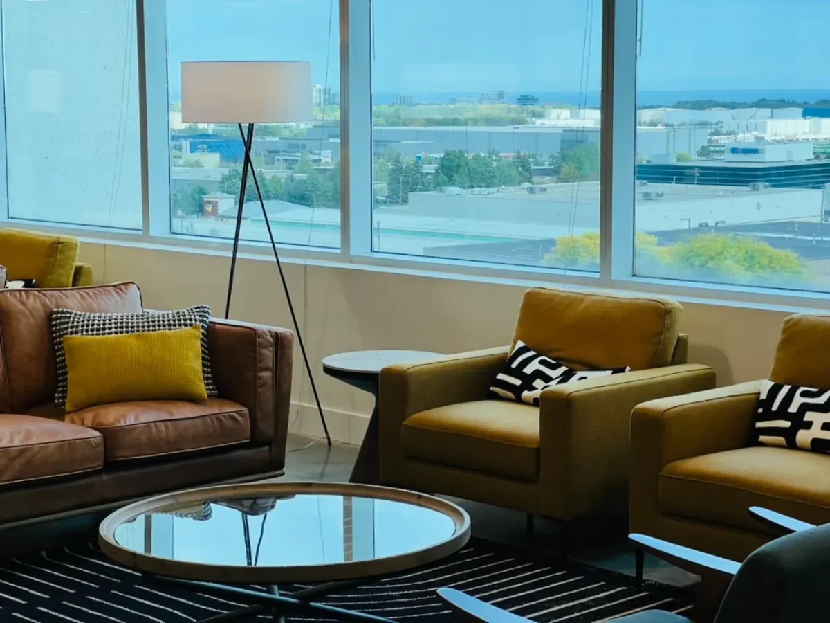 Bright waiting lounge at the office with armchairs and large windows